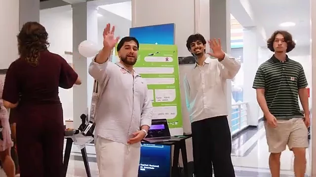 A team pitching visitors at their stand, EIA 2026